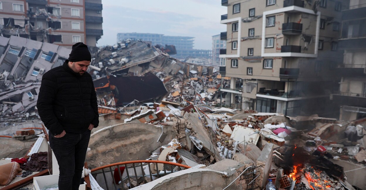 turkey-add1 A man standing amid rubble looks at the damage following an earthquake in Hatay, Turkey, on Tuesday. Photo: REUTERS/Umit Bektas
